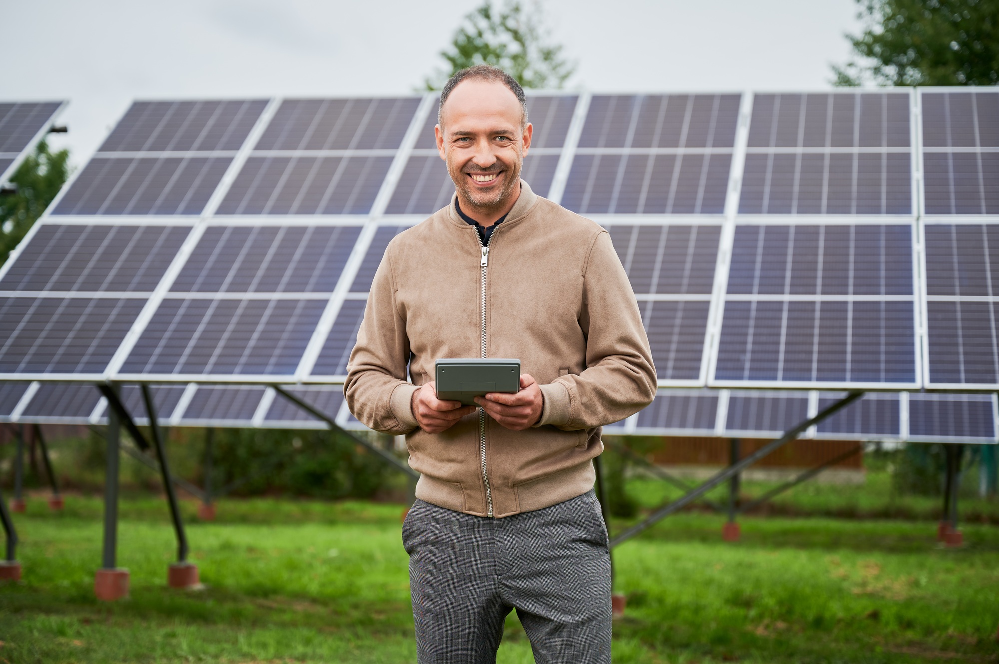 Glad man calculating his income from investments in alternative energy.
