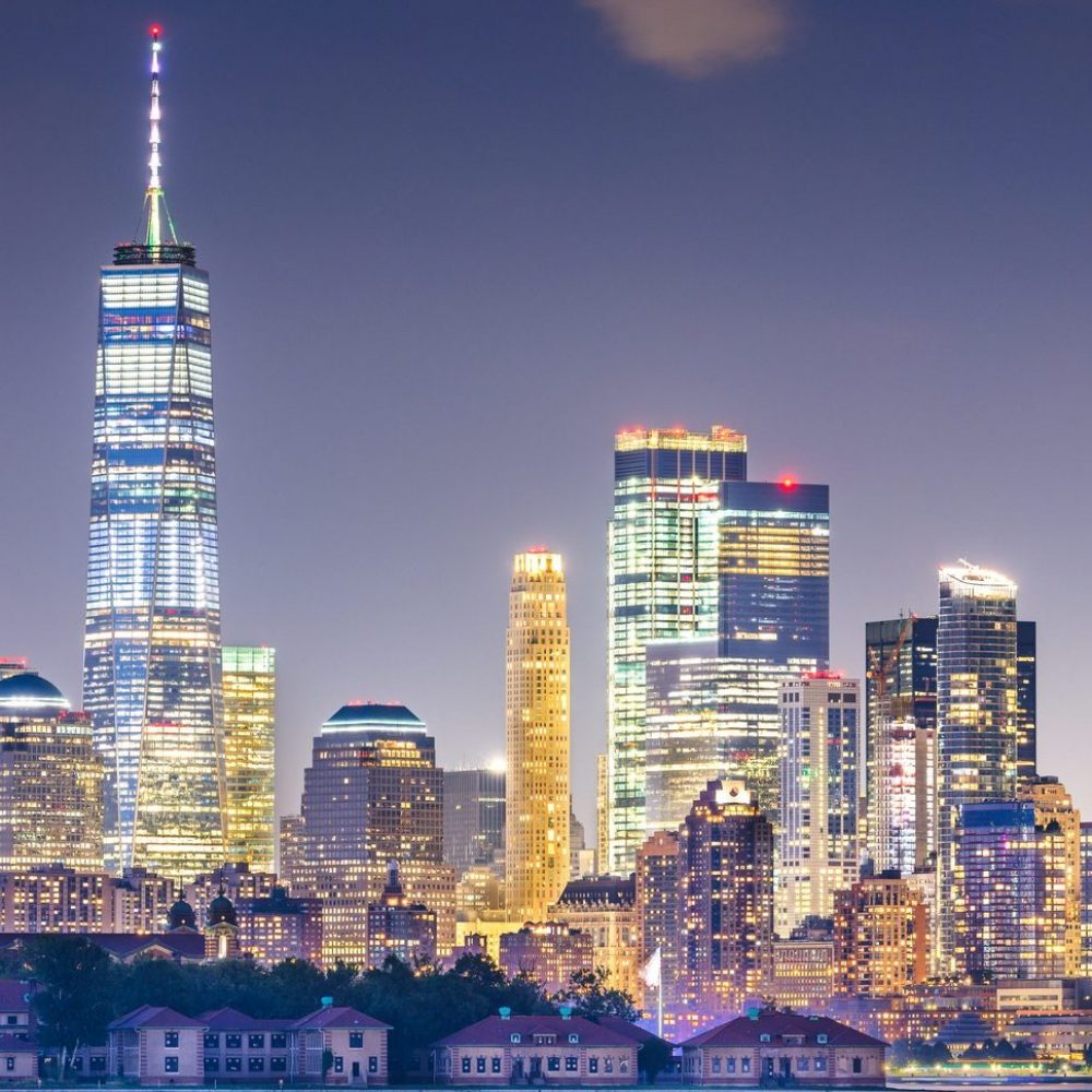 New York, New York, USA skyline from the harbor with Ellis Islan